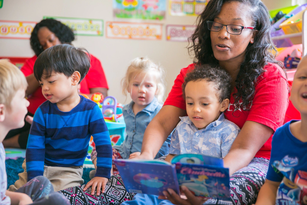 Daycare provider reading to children