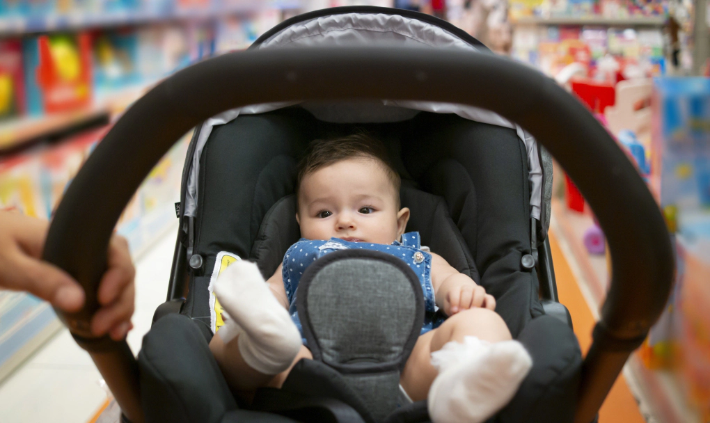 A safe sleep space, car seat, diapers and wipes, clothing, bottles and formula (if not breastfeeding), and a stroller are essential baby gear you’ll need. 