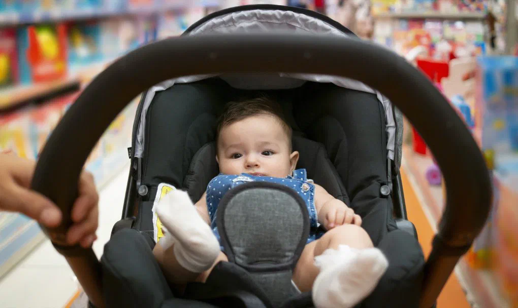 A safe sleep space, car seat, diapers and wipes, clothing, bottles and formula (if not breastfeeding), and a stroller are essential baby gear you’ll need. 