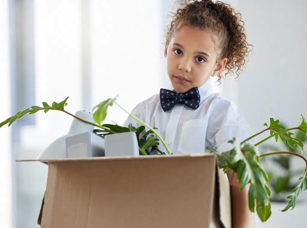 A child playing in a moving box as a family relocates for a new job