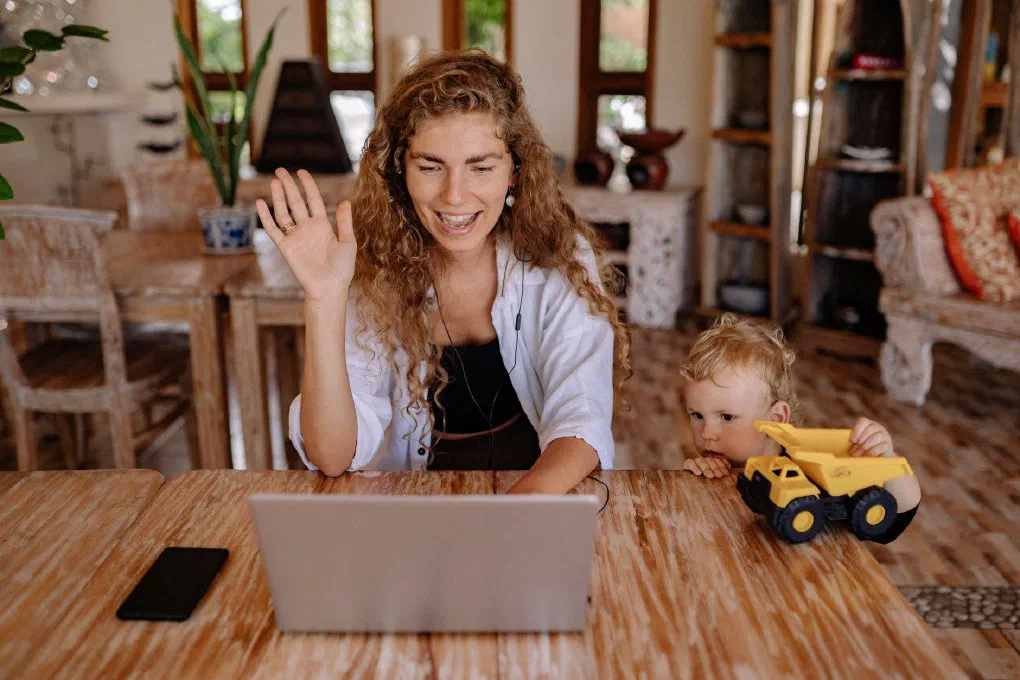 A mother and her son engaging in a joyful video call, sharing a family moment at home.
