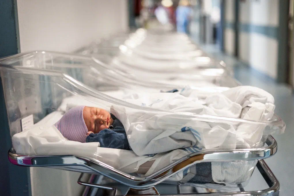 A newborn in the hospital, representing the need for maternity leave
