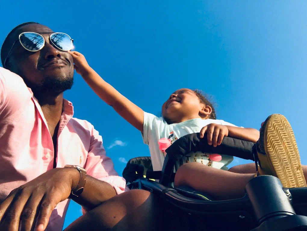 A father and child sharing a tender moment together outdoors