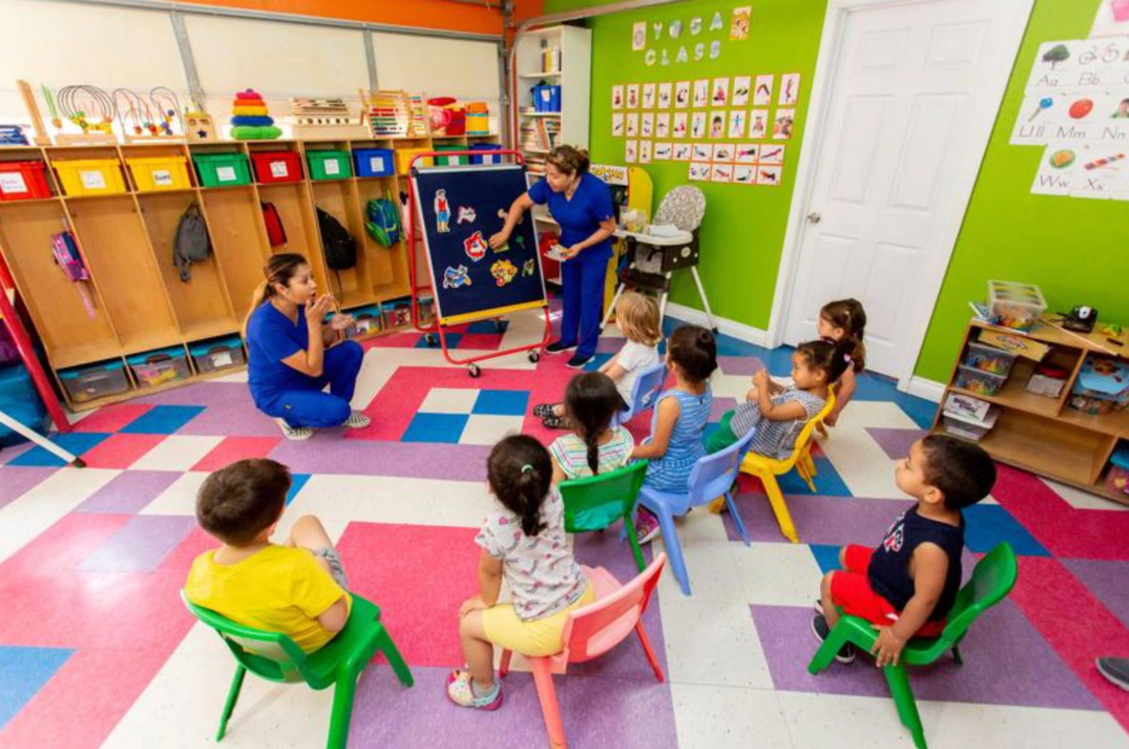 Upwards daycare providers instructing students in the classroom.