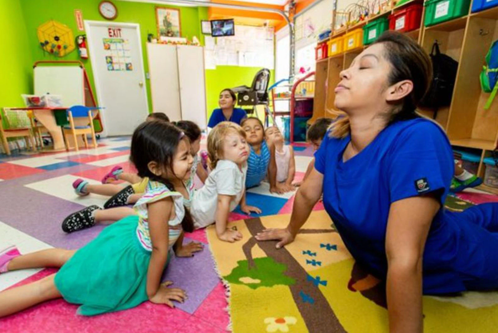 Upwards childcare provider Tanya Garcia leads children in healthy activities such as yoga.