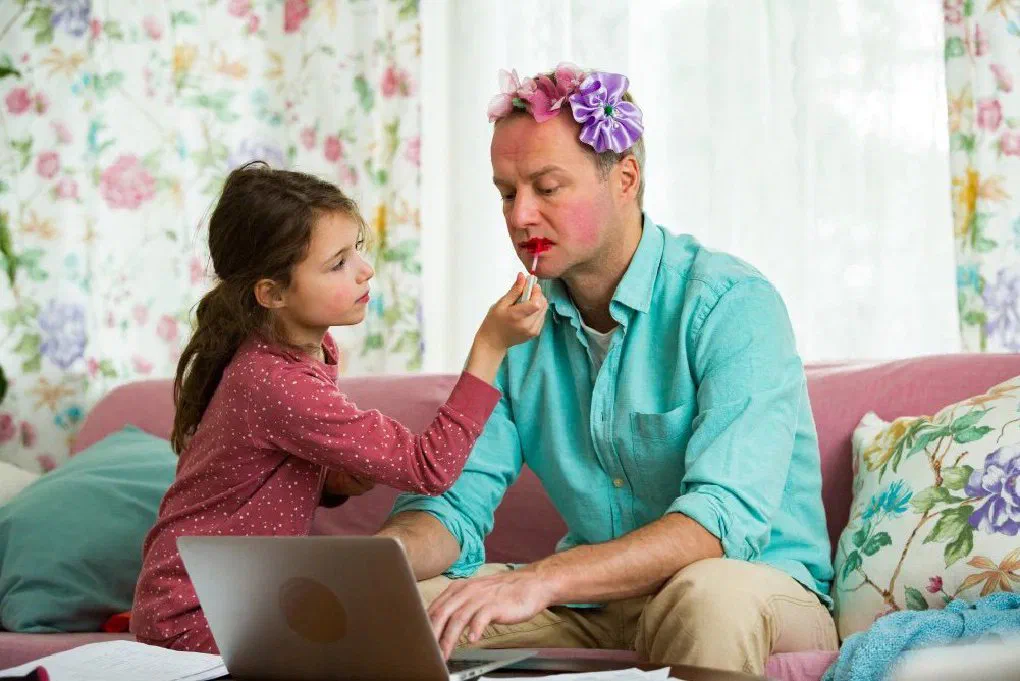 A remote employee working from home alongside their young child