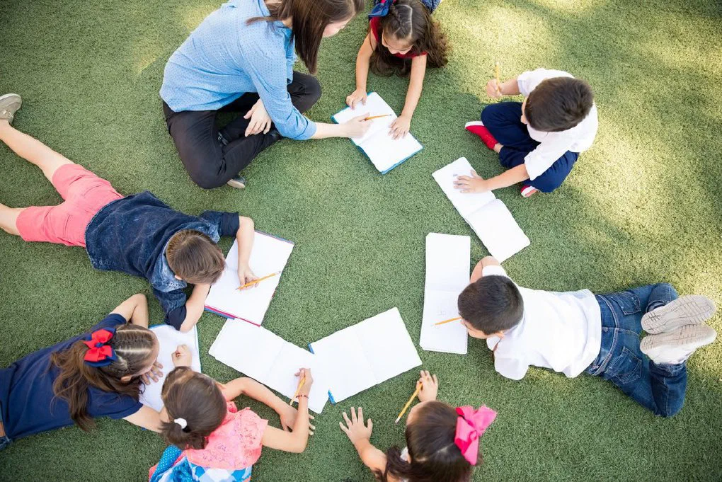 A child giving a thank-you gift to their teacher for Teacher Appreciation Week