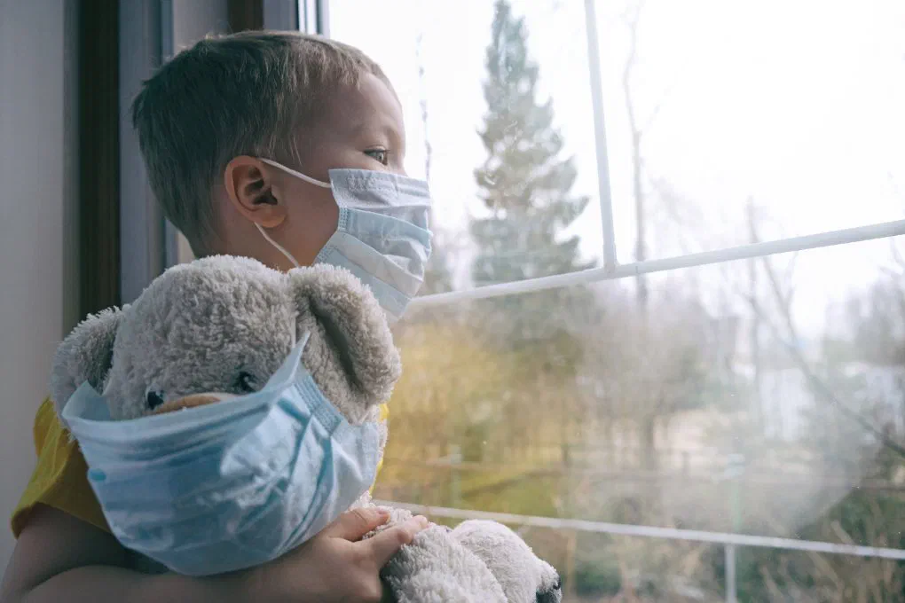 A masked teddy bear representing parents' childcare challenges during the crisis